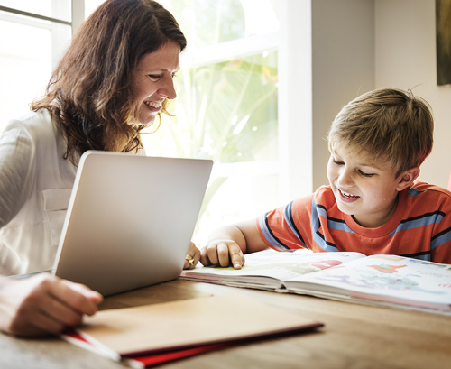 Mother and her son doing homework image