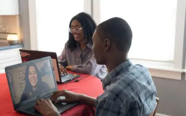 Students working with their laptops at home